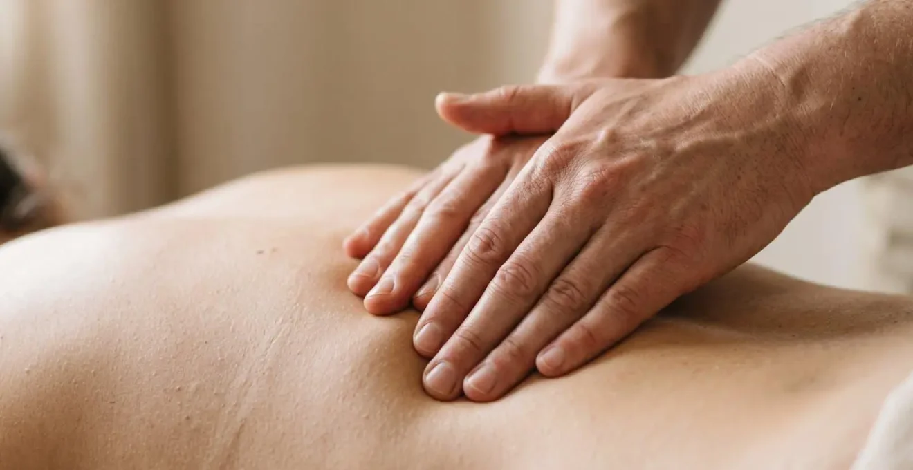 Close-up of hands applying counter-pressure technique on lower back during labor