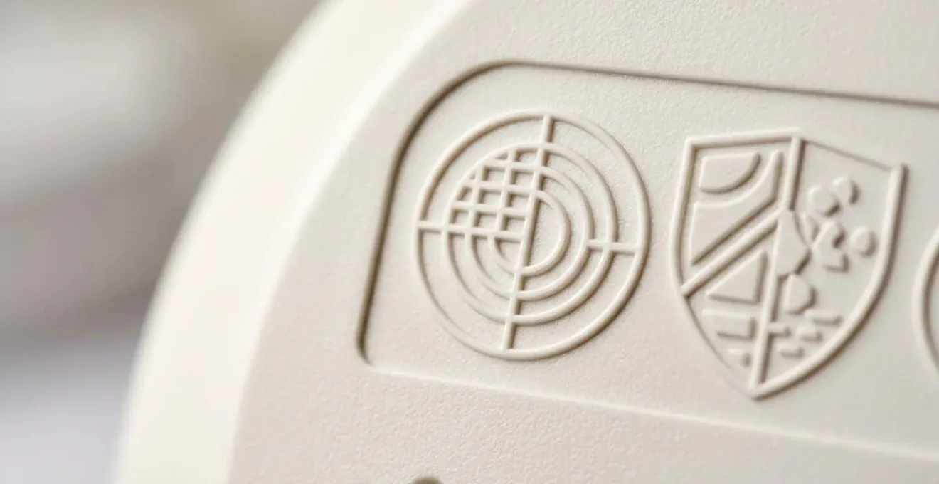 Close-up view of British Standards certification marks on carbon monoxide alarm
